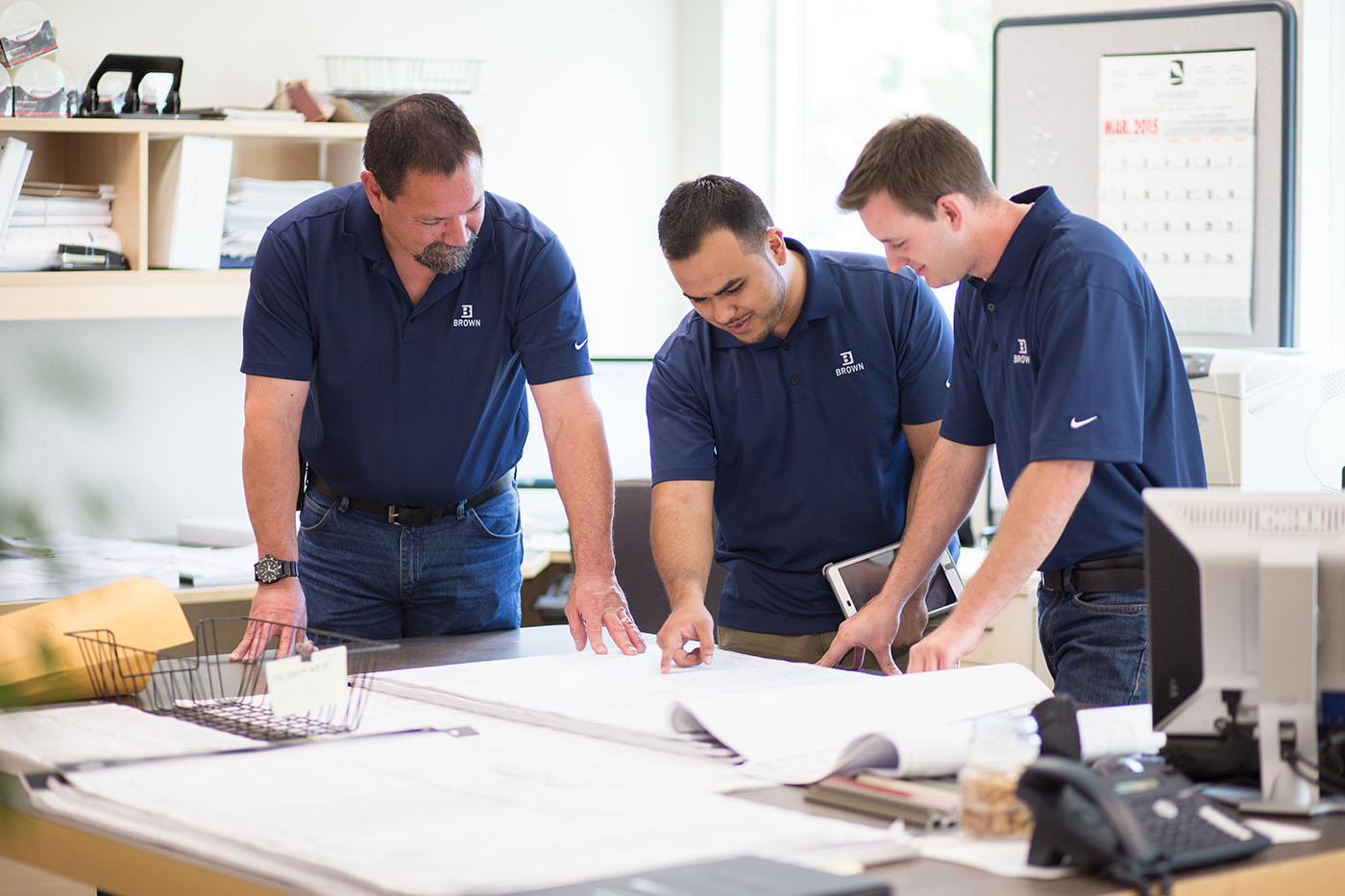 Brown Construction estimator teaching two interns