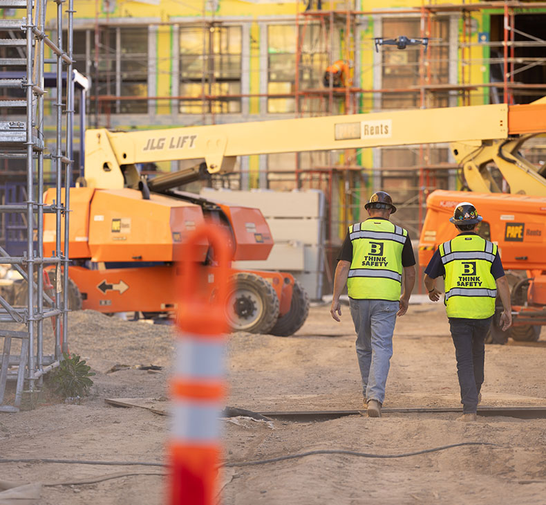 Nate Smith and Jacob Snyder walking Aggie Square job site together