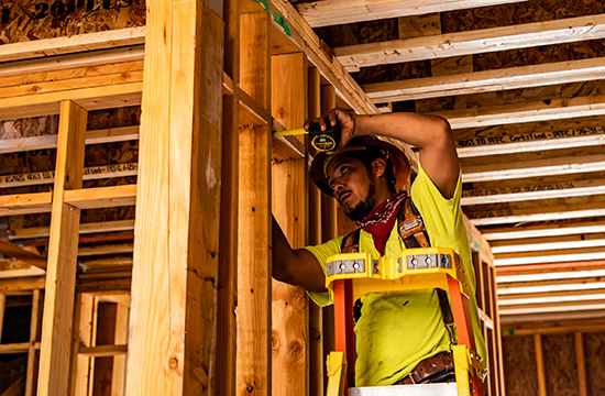 Plumbing subcontractor measuring framing on Holden IL Roseville-XSiGHT