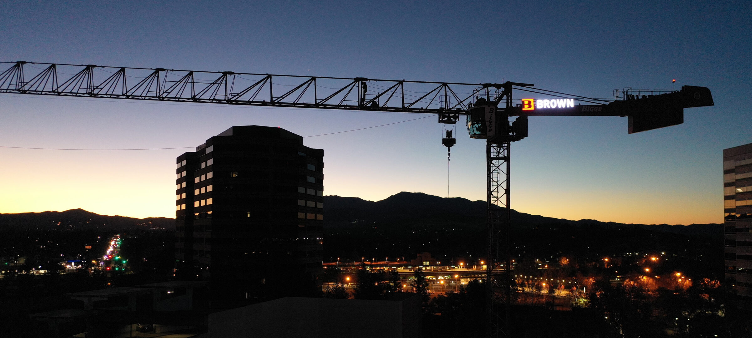 Tower crane with Brown Construction sign at The Grant in Concord